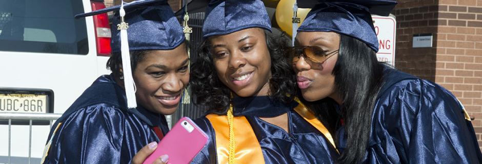 Students at graduation in caps and gowns at CCP/