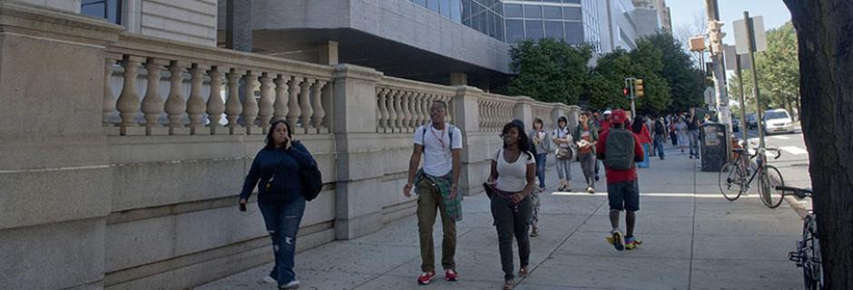 Students walking on Spring Garden Street in front of the Mint Building