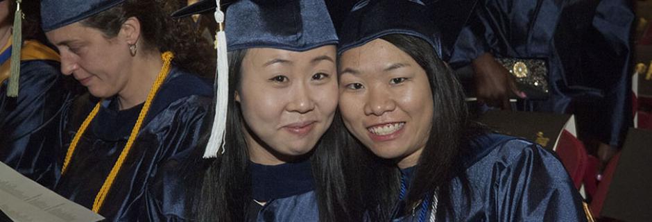 Two students in graduation caps and gowns at CCP.