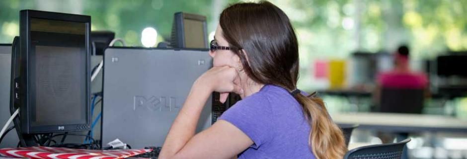 Student working at computer in CCP library.