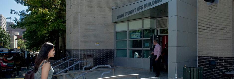 Student walking into Winnet Student Life Building at CCP.