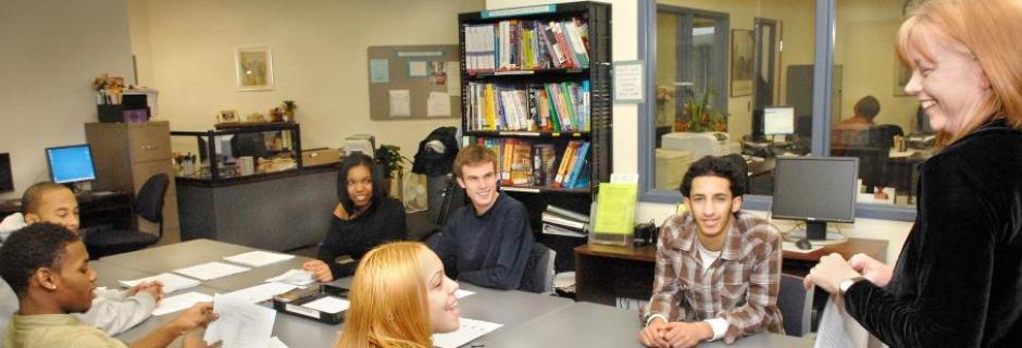 Students around table smiling