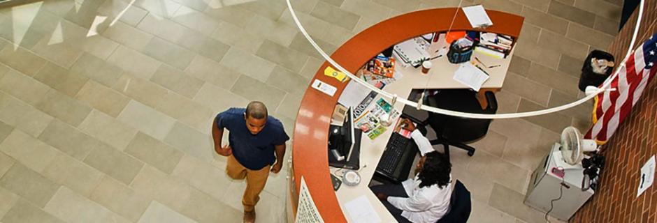 Student Walking Past Desk at Community College of Philadelphia.