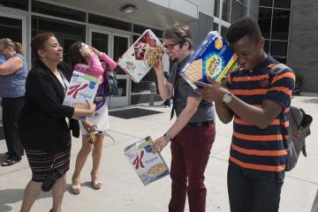 Faculty, staff and students share homemade viewing boxes.