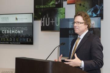 Dr. Sam Hirsch speaks to the crowd about the dual admissions signing agreement