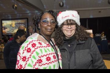 Staff dressed in holiday-themed clothes pose for the camera