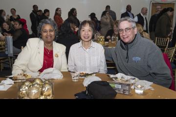 Three attendees pose for the camera