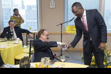 President and CEO of the Philadelphia Tribune, Robert Bogle, chooses the winning lottery card for guests of the breakfast