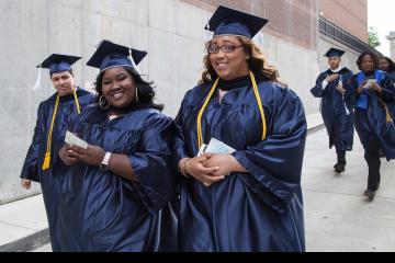 Graduates arrive to line up for graduation.