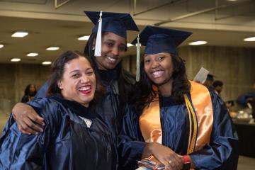 Group of graduates smiles for the camera.