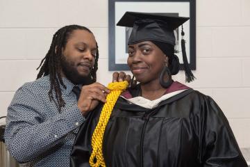 Faculty member dresses for the ceremony.