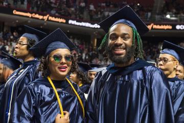 Graduates gather inside the arena.