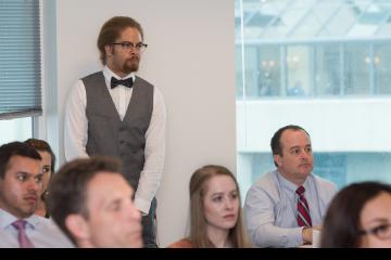 A young lawyer listens in class.