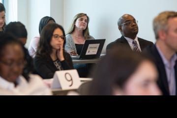 A lawyer listens in class.