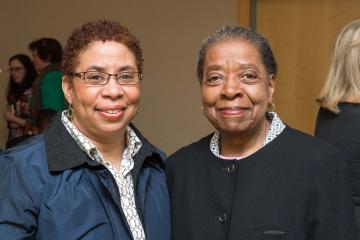 Two attendees smile for the camera.