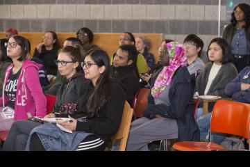 The audience listens to Dr. Generals