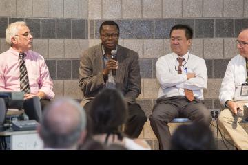 A panel member addresses the crowd.