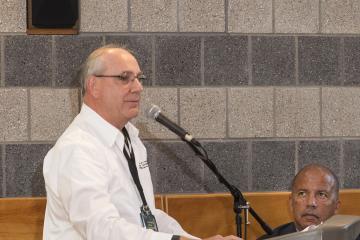 A panel member addresses the crowd.