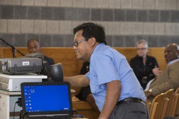 A panel member prepares his visual presentation.