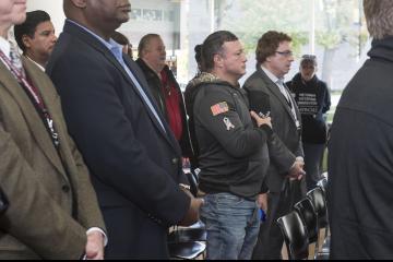 An audience member covers his heart as the National Anthem is sung.