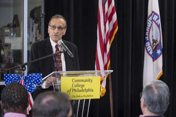 Faculty member and veteran, Ralph Faris, addresses the audience.