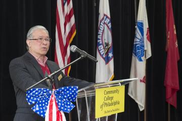 Veteran and College staff member Quyen Ngo addresses the audience.