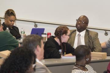 A staff member of President Sygielski, addresses the audience.