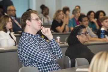 An audience member listens attentively.