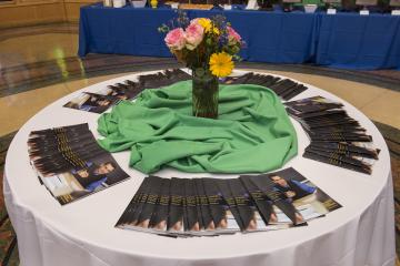 A print publication celebrating the college's Latino/a aculty decorates a table