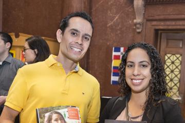 Faculty featured in the publication smile for the camera while holding the publication