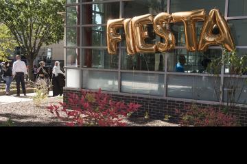 Helium balloons spell out FIESTA to welcome students, staff, and faculty to the LatinX Month Fiesta celebration in Winnet Courtyard.