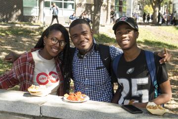 Students enjoying their food smile for the camera.