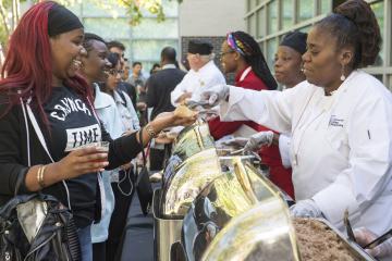 Culinary Arts students serve food to the crowd.