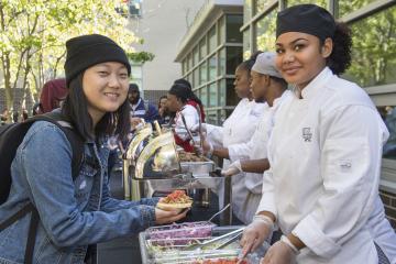 A Culinary Arts student and another student smile for the camera.