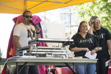 The DJ tells the crowd about the entertainment, as well as about the donations table set up for hurricane relief for Puerto Rico.