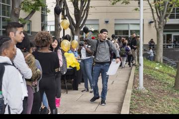 A student waiting in line enjoys the music filling Winnet Courtyard.