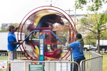 Riders are a spinning blur in the "Tumbleweed" ride.