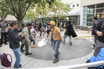 An enthusiastic group dance to the music.