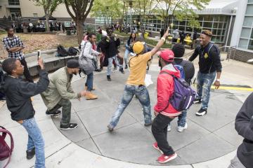 An enthusiastic group dance to the music.
