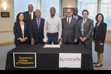 Speakers and Participants in crafting the agreement pose for the camera.