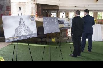 Two party goers view historical information posters.