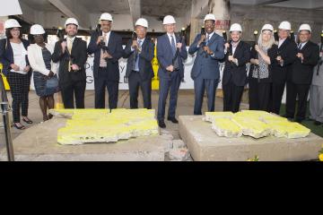 Community College Dignitaries and Radner Property Group executives lift their sledge hammers for the ceremony.