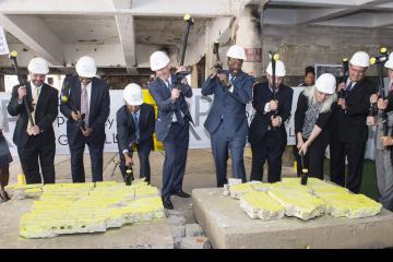 Community College Dignitaries and Radner Property Group executives swing their sledge hammers for the ceremony.