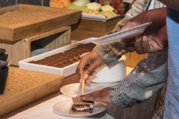 An attendee makes a s'more.