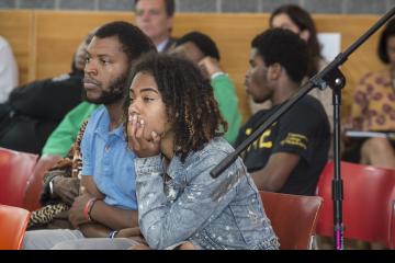 A young audience member listens intently.