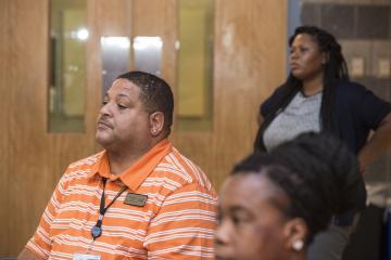 An audience member listens to the discussion.