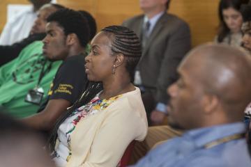 An audience member listens to the discussion.