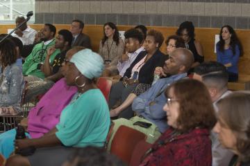 The audience listens to the discussion.