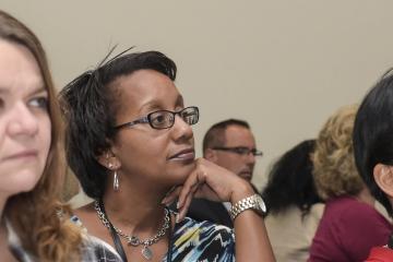 An audience member listens to Dr. Generals speech.