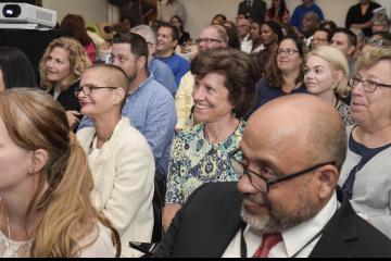 The audience enjoys humorous movie clips.